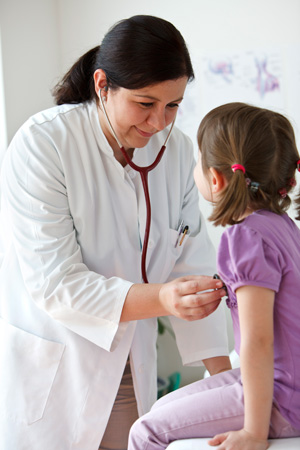Doctor with stethoscope attending to a child