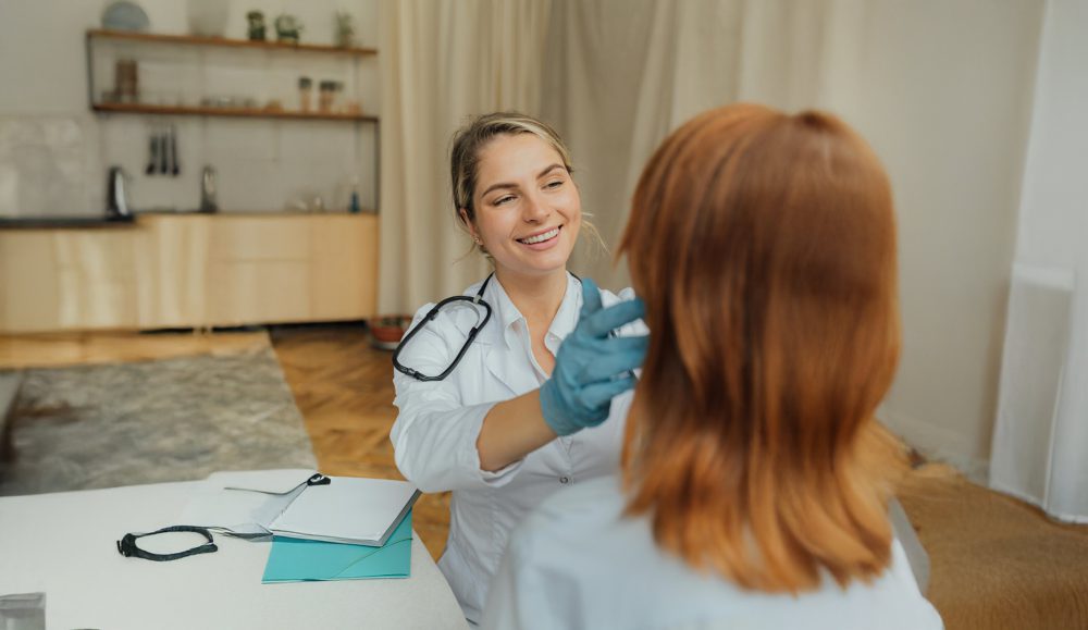 A doctor looking at a patient with care