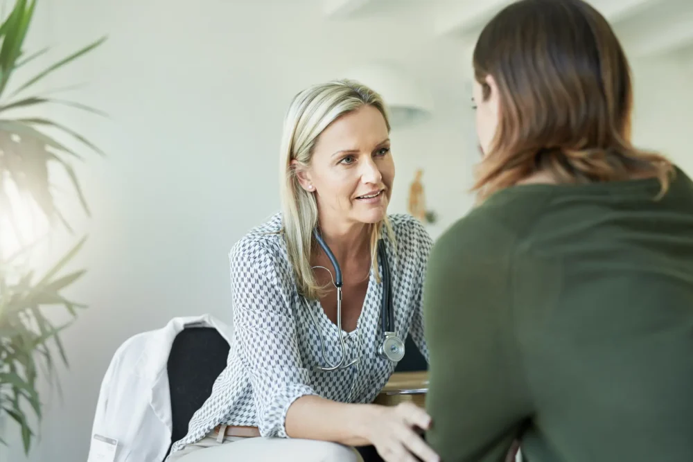 A doctor looking at a patient with care