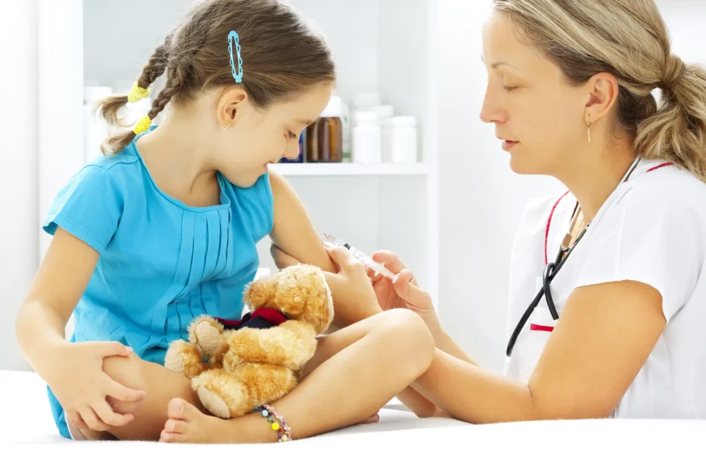 Doctor using a needle on a child patient
