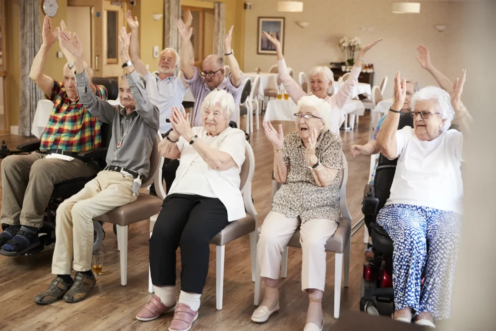 Group of eldery people having fun with their hands in the air